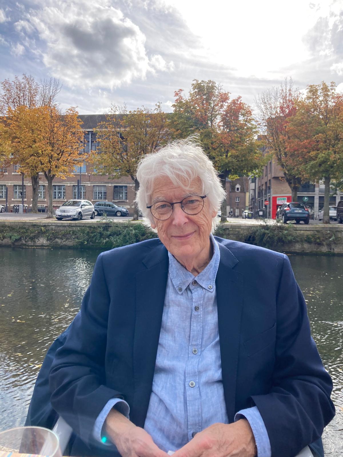 Patrick Marnham seated beside a canal